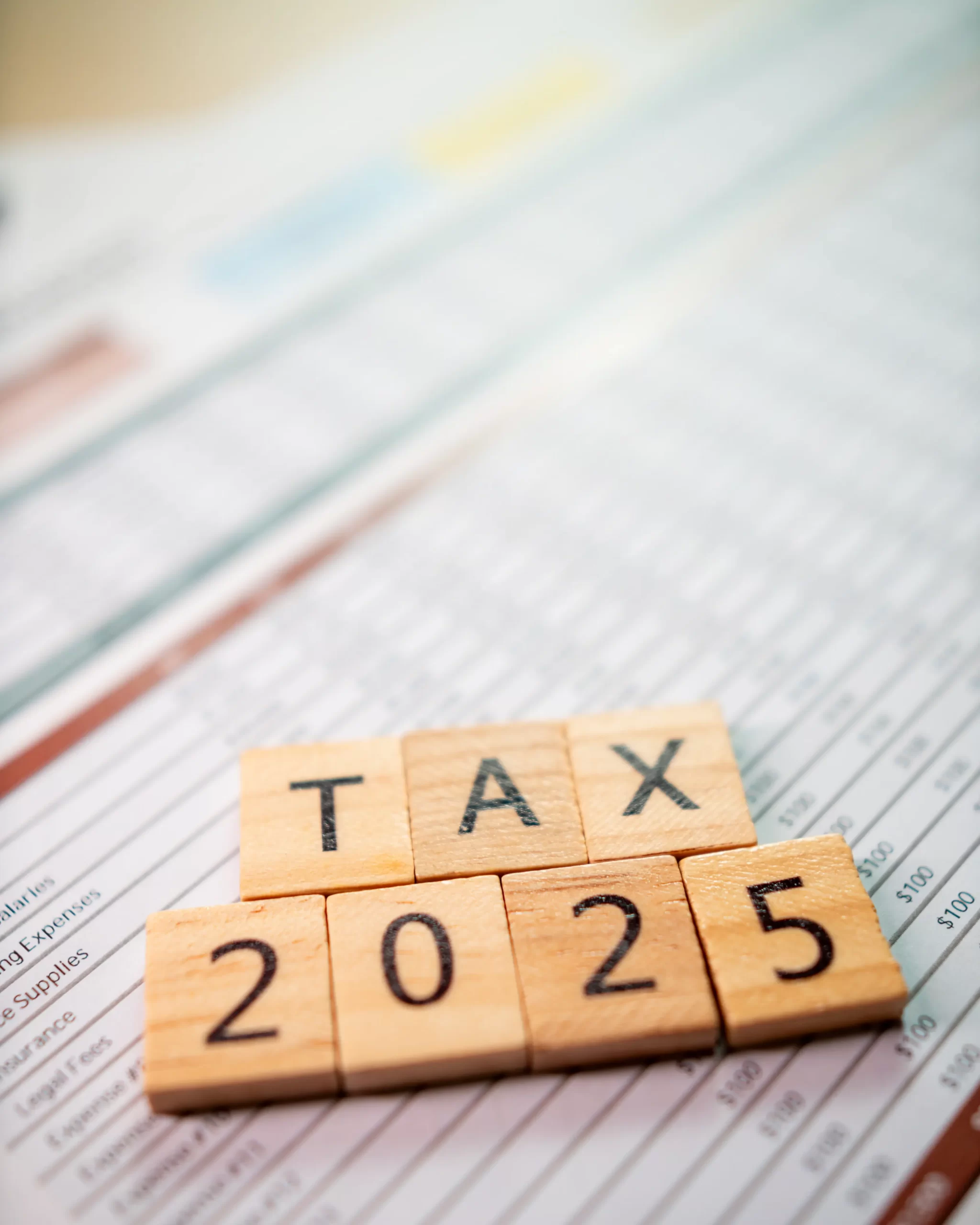 Income tax filing preparation: A business professional organizing financial documents on a desk for tax season 2025.