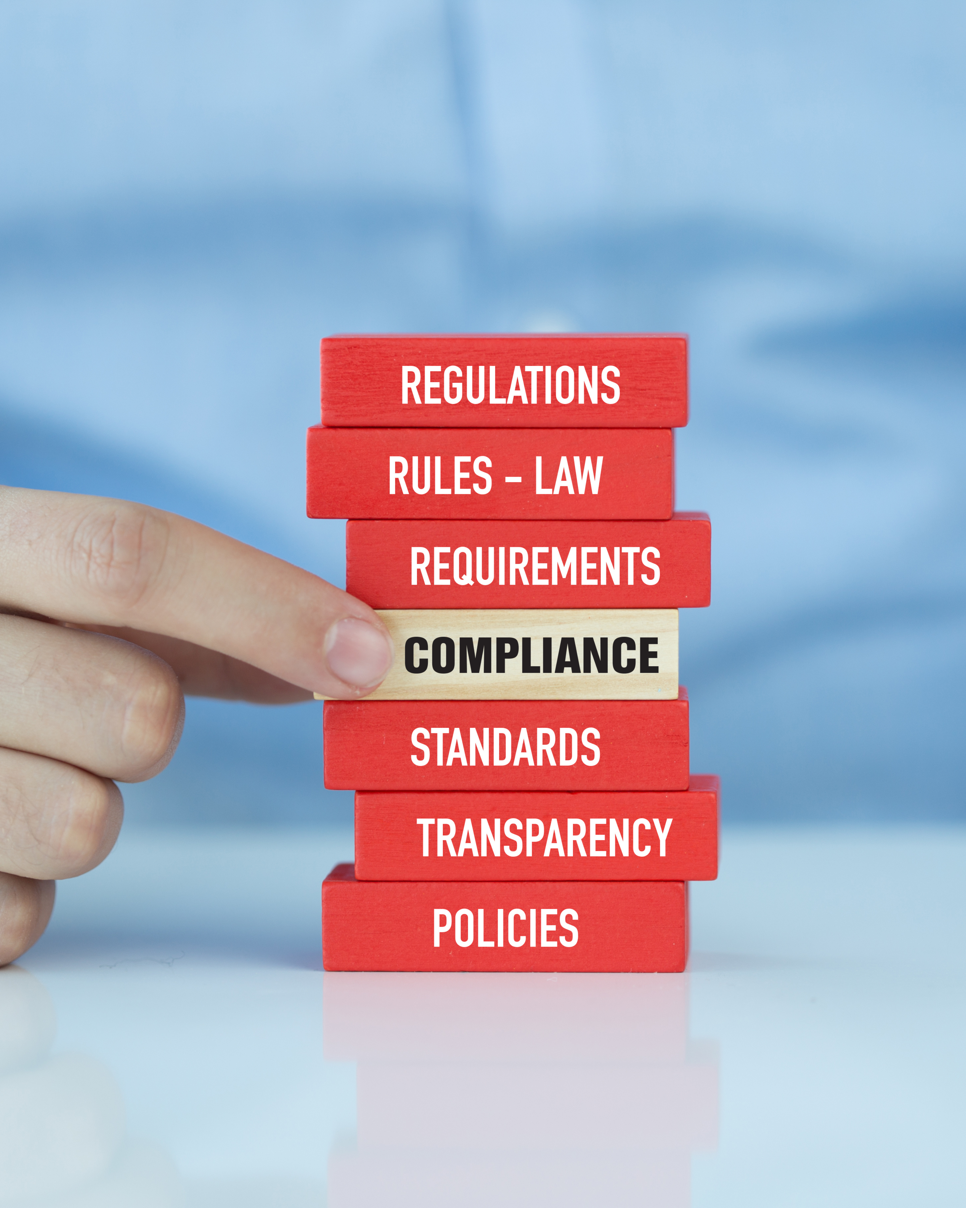 Compliance checklist being reviewed by a business owner on a laptop in office